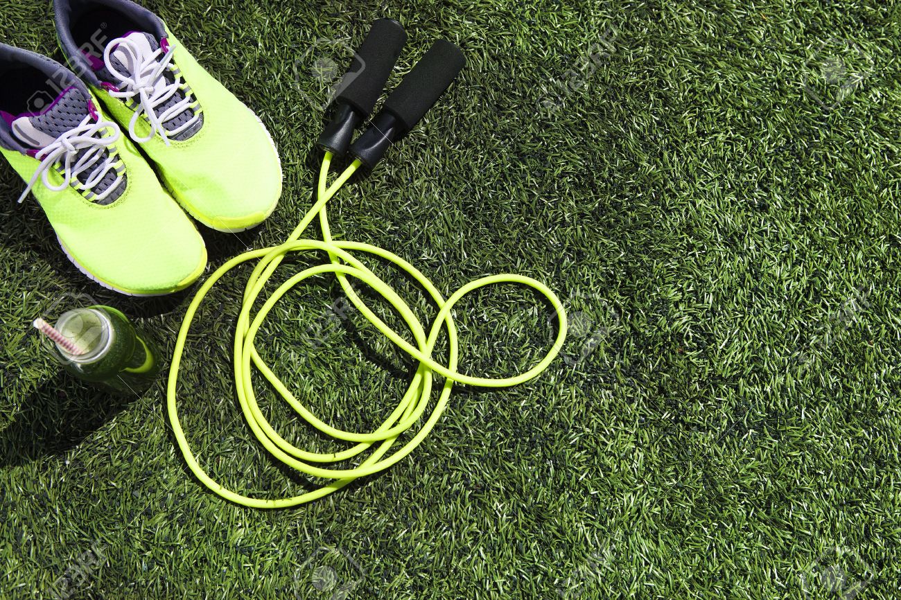 Running shoes, jump rope and drink bottle with green juice on grass background - 52141721 Running shoes, jump rope and drink bottle with green juice on grass background - 52141721