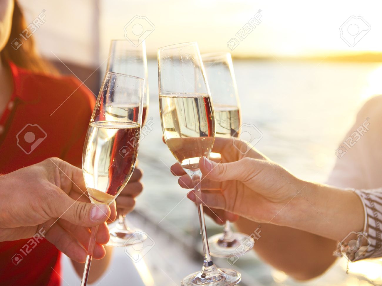 Happy friends with glasses of champagne on yacht. Vacation, travel, sea and friendship concept. Closeup. - 53651761 Happy friends with glasses of champagne on yacht. Vacation, travel, sea and friendship concept. Closeup. - 53651761