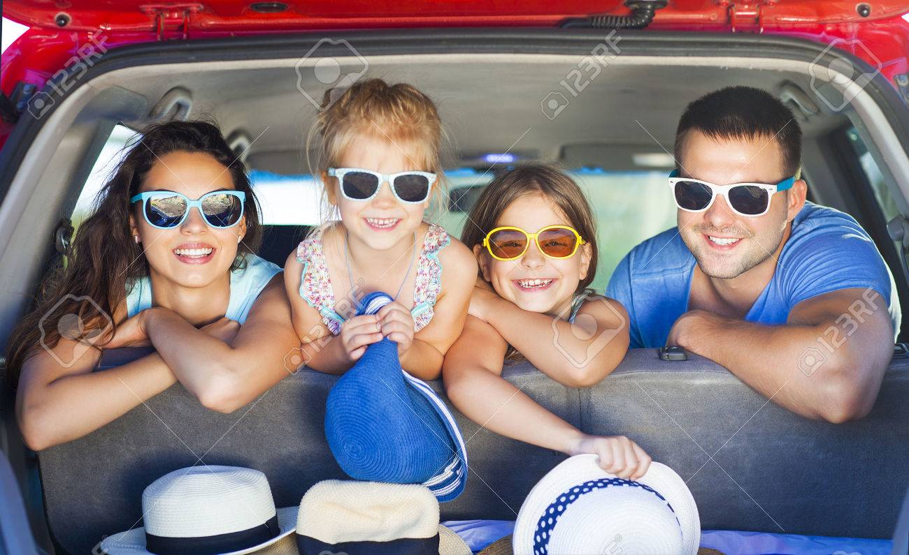 Portrait of a smiling family with two children at beach in the car. Holiday and travel concept - 57292319 Portrait of a smiling family with two children at beach in the car. Holiday and travel concept - 57292319