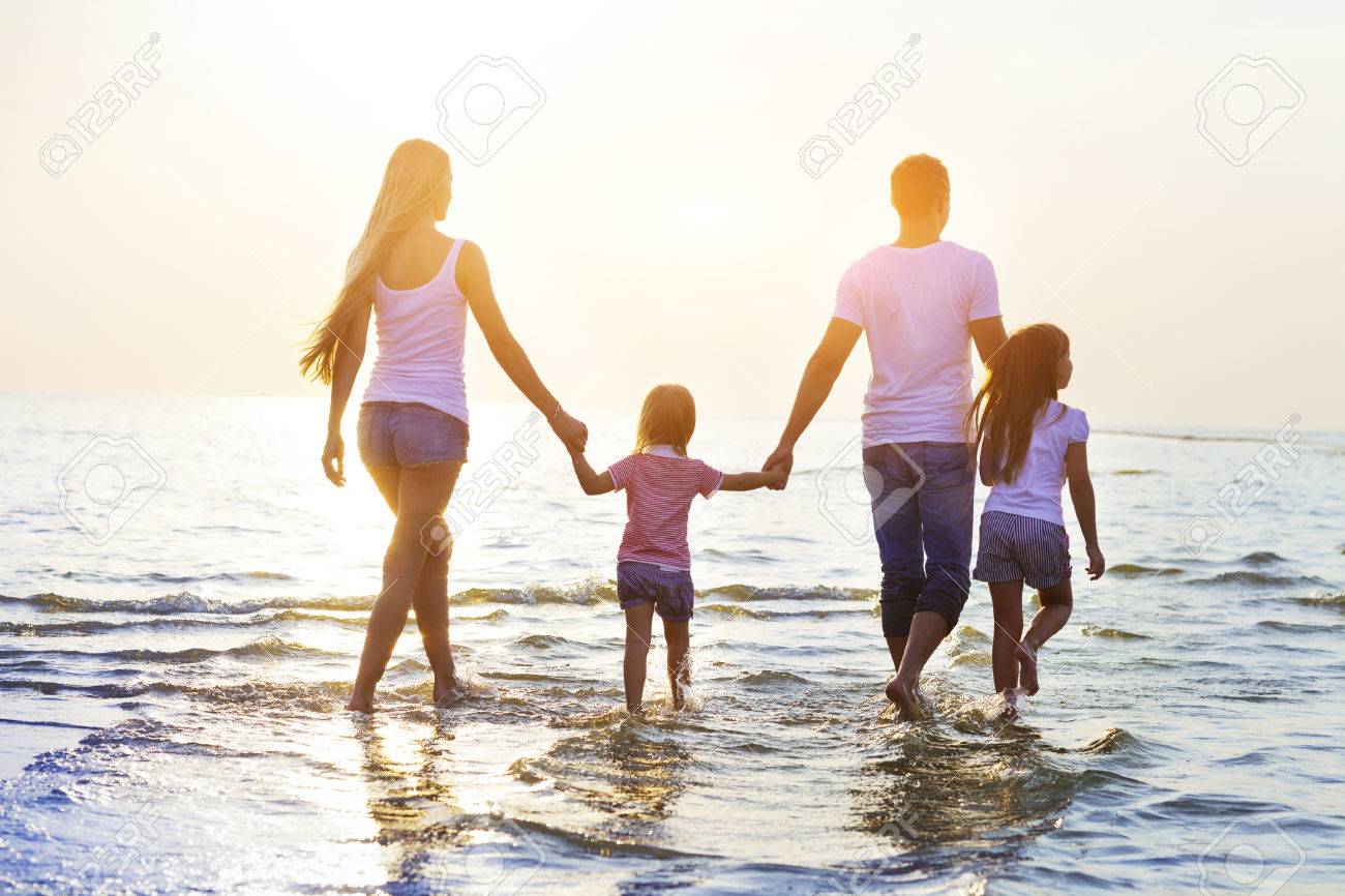 Happy young family having fun running on beach at sunset. Toned photo. - 60415761 Happy young family having fun running on beach at sunset. Toned photo. - 60415761