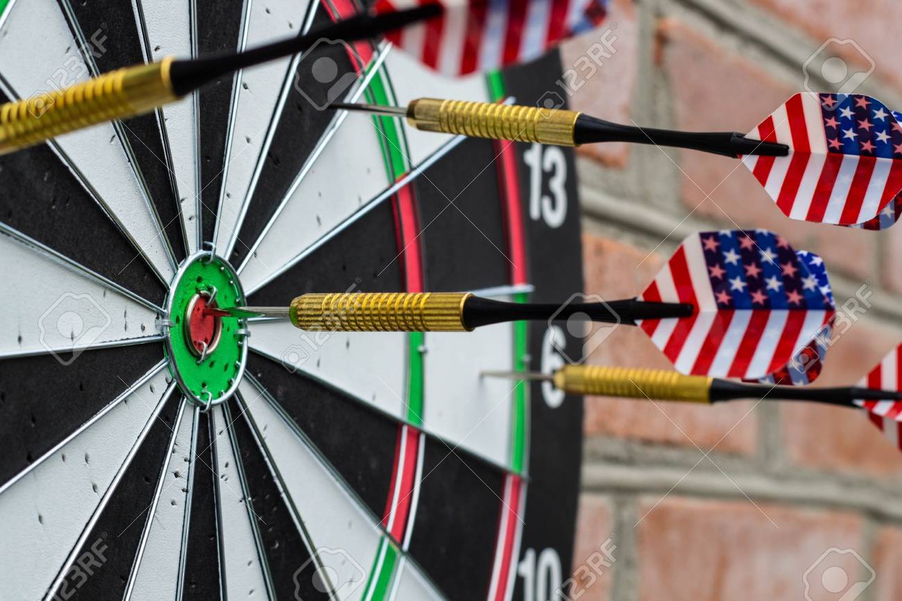 dart in bullseye on the target with many other darts the concept