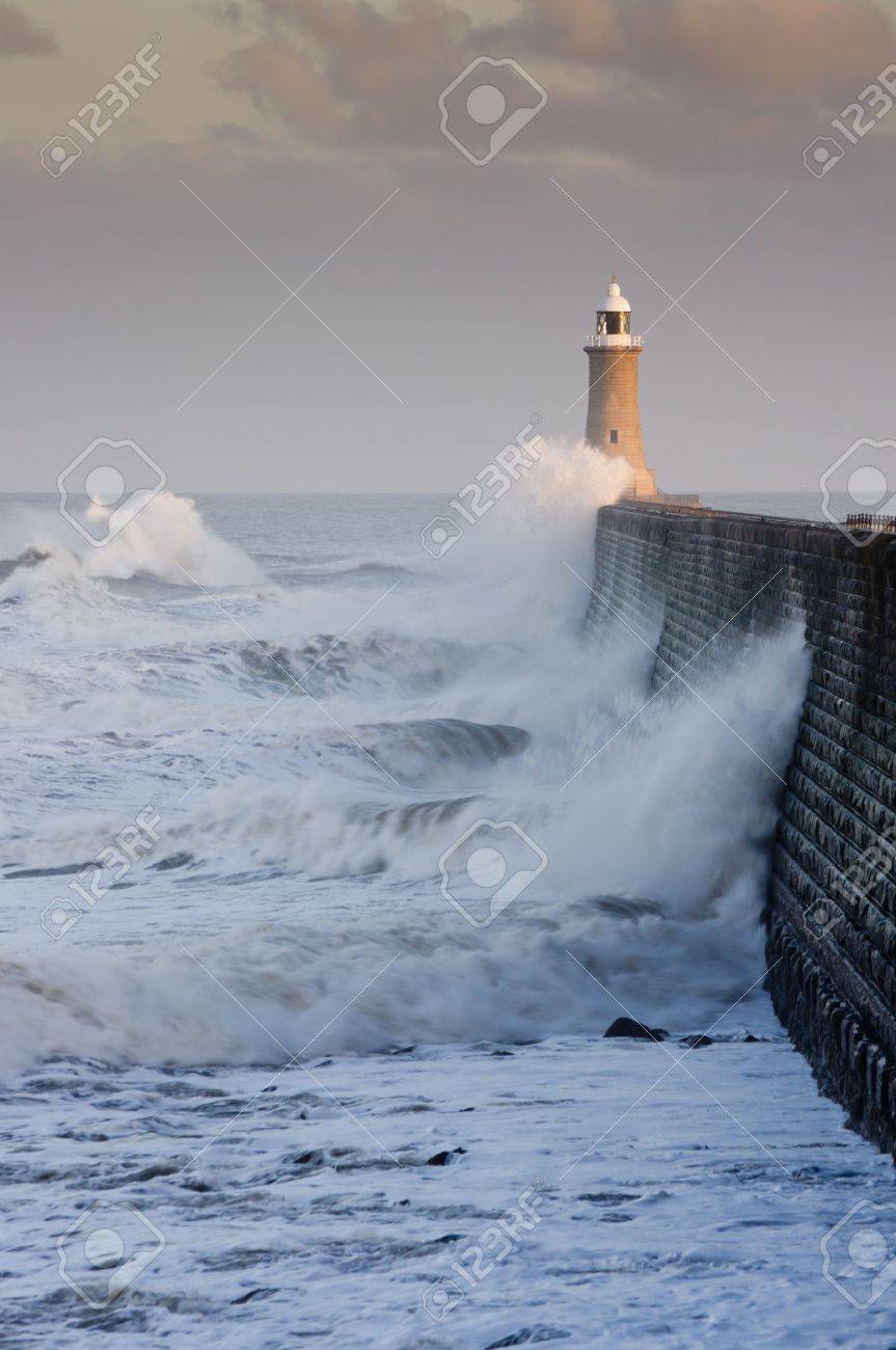 Tynemouth north pier with waves crashing against it and the lighthouse - 12693024 Tynemouth north pier with waves crashing against it and the lighthouse - 12693024