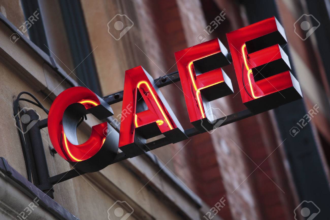 Neon cafe sign with out of focus building in the background. - 42541039 Neon cafe sign with out of focus building in the background. - 42541039