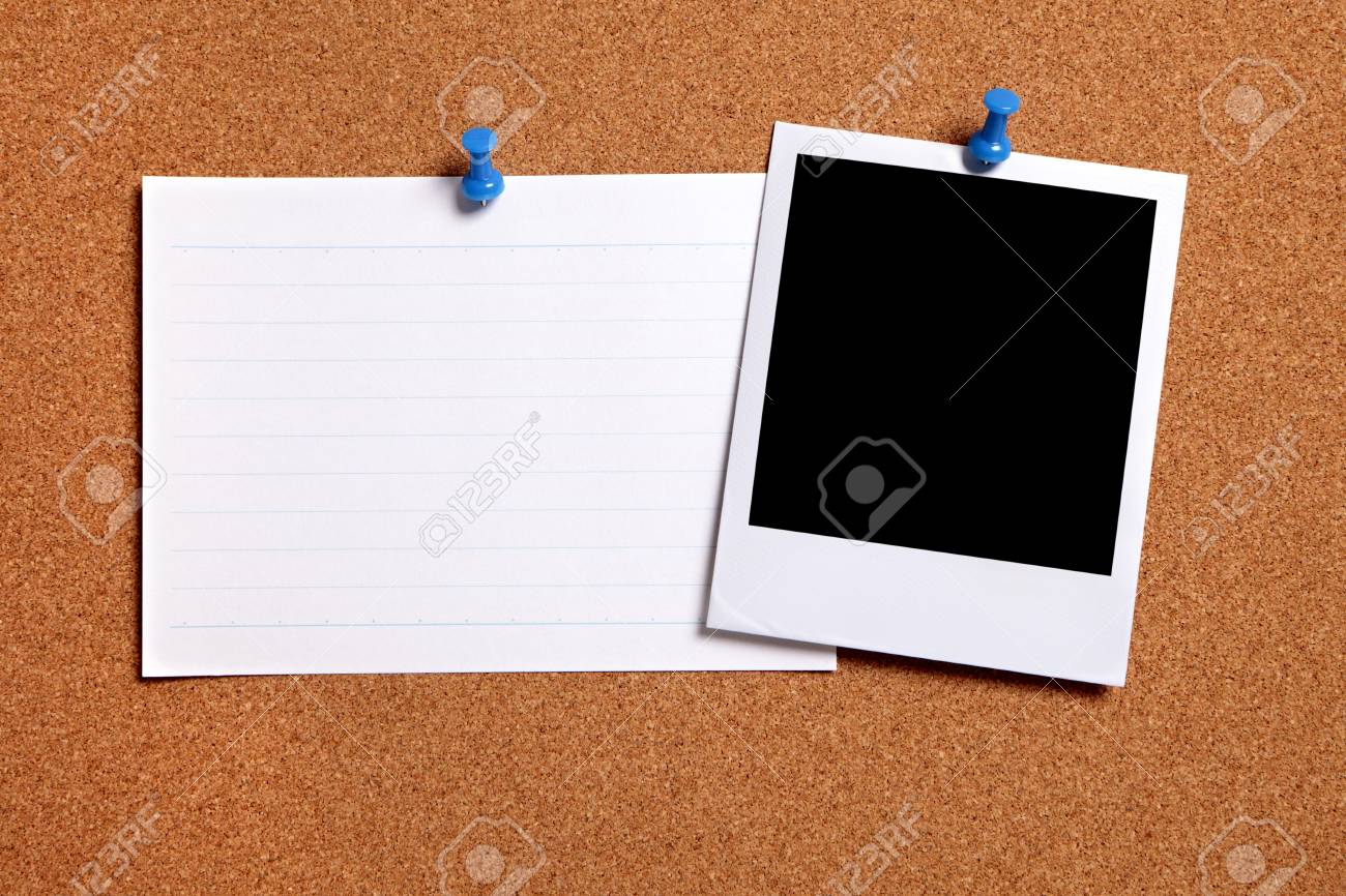 blank photo print and office index card pinned to a cork notice printing on an index card