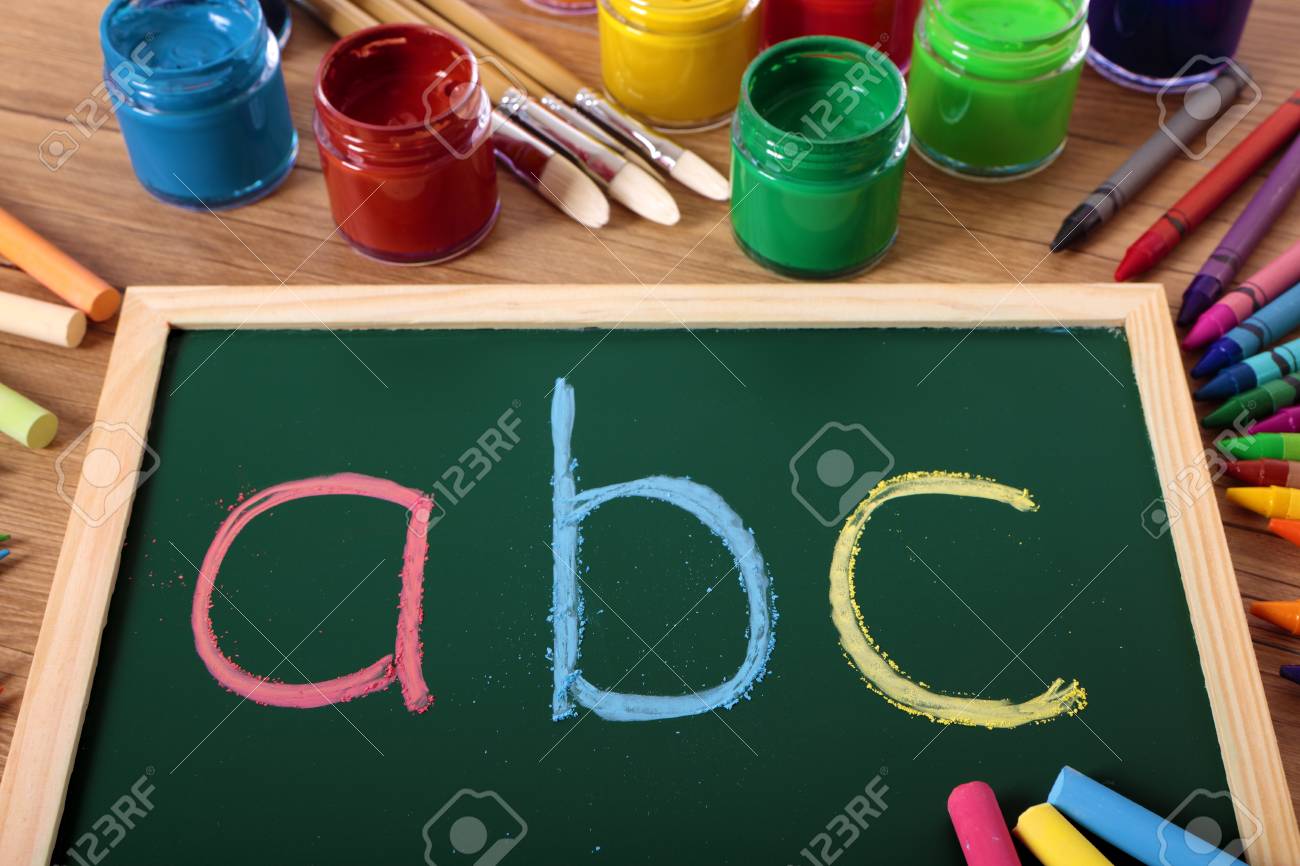 abc written in color chalk on a small elementary blackboard with