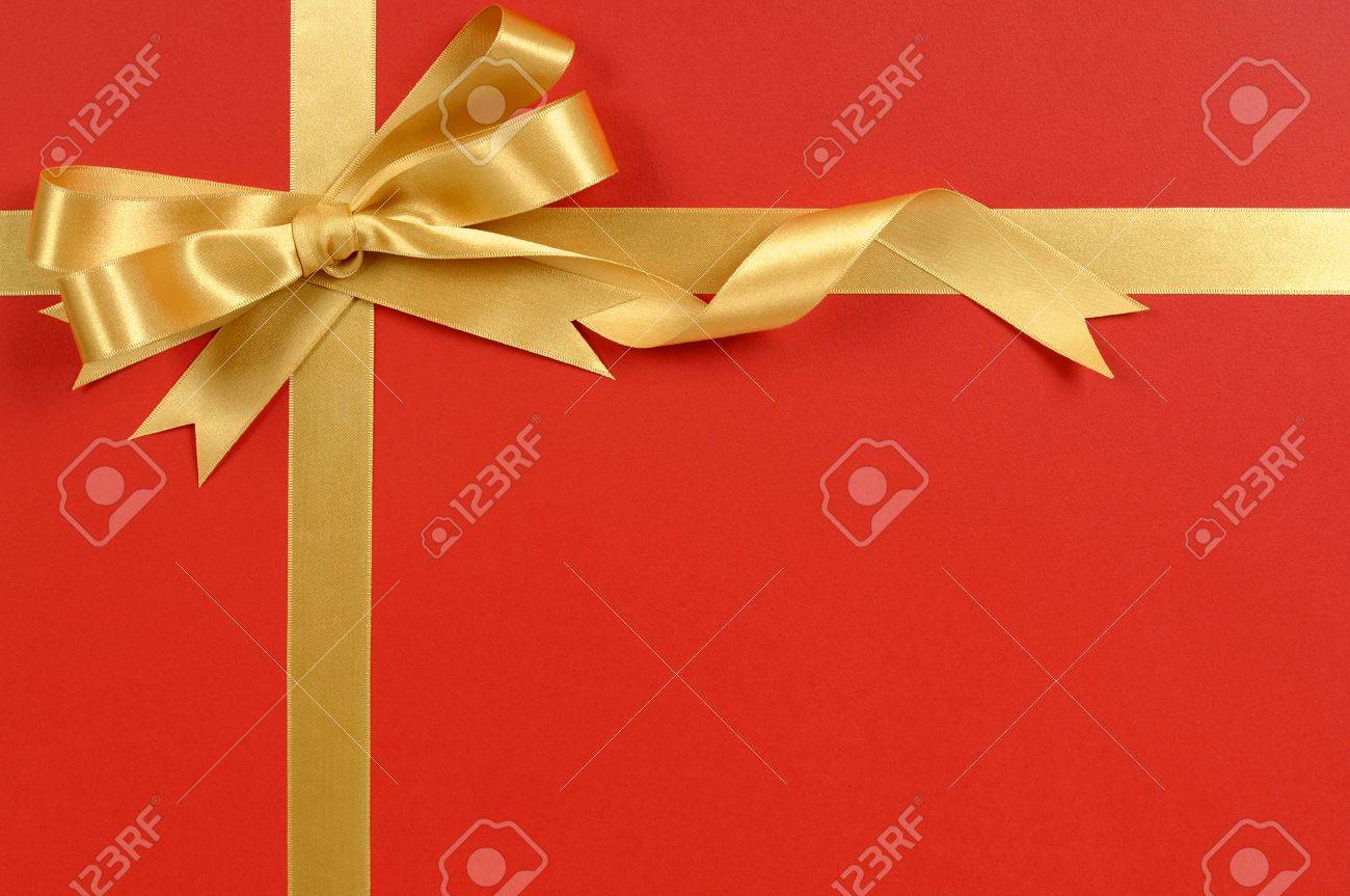 gold ribbon bow red gift wrap background copy space stock photo