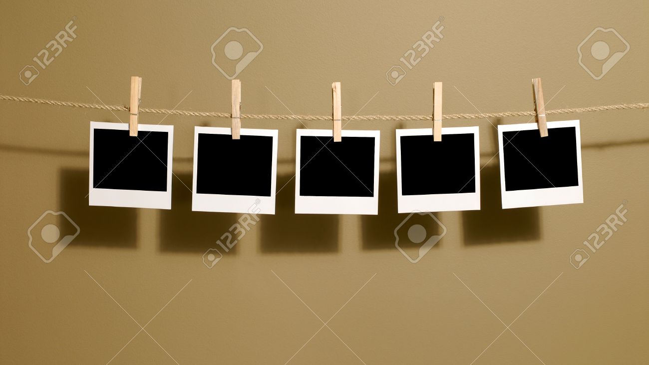 polaroid style instant photo prints hanging on a rope or washing