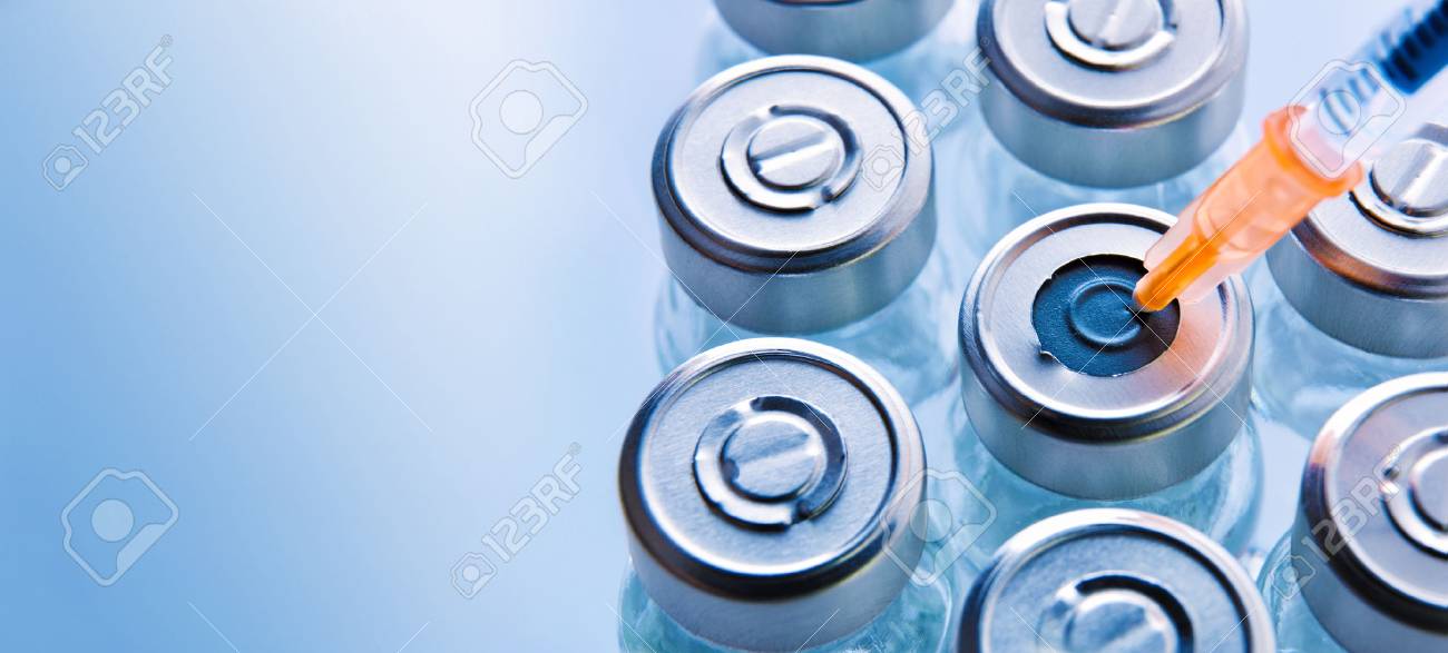 Group of vials with medication and punctured syringe on blue methacrylate table. Horizontal composition. Top view. - 88561061 Group of vials with medication and punctured syringe on blue methacrylate table. Horizontal composition. Top view. - 88561061
