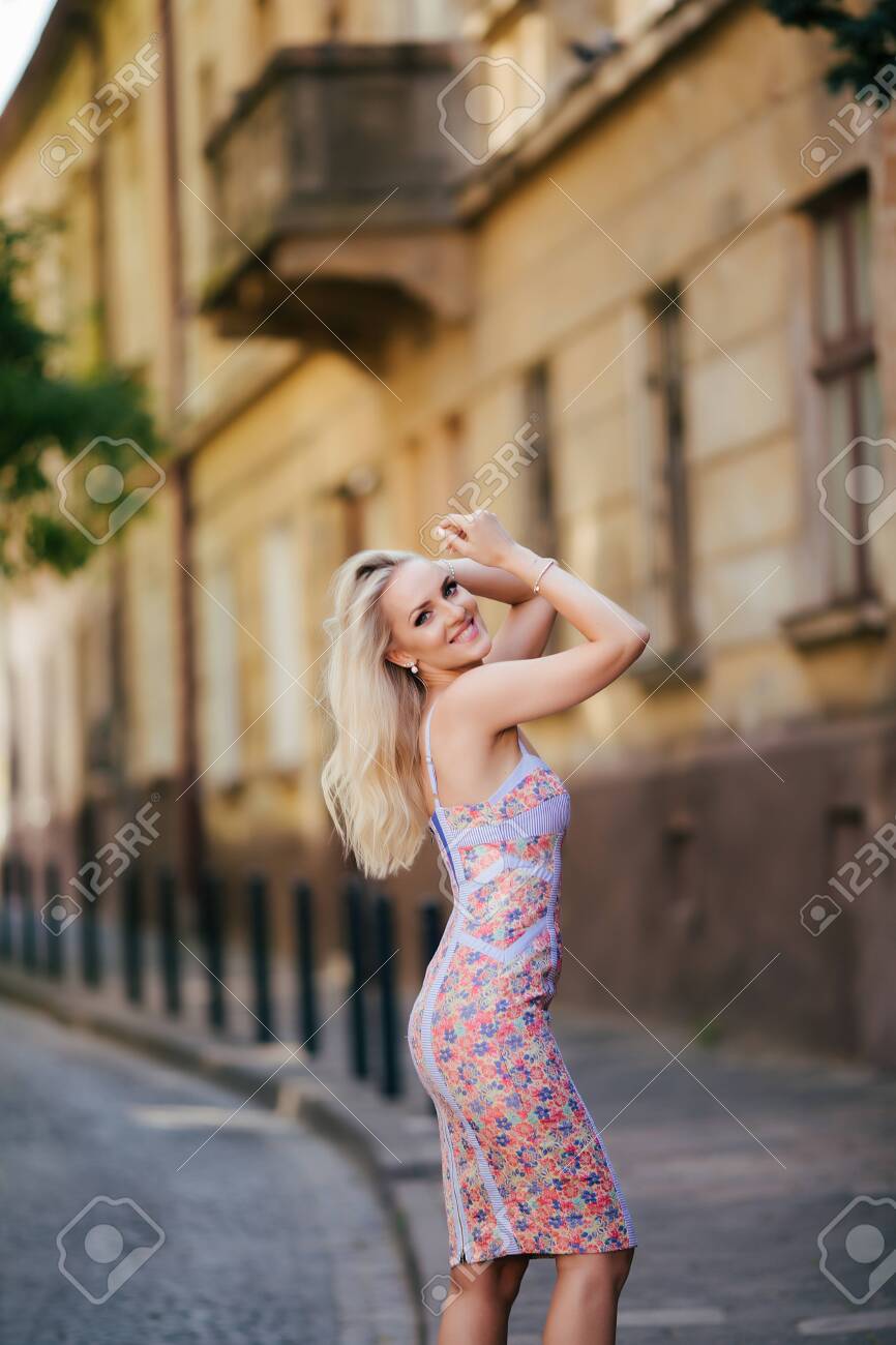 Beautiful Attractive Woman Standing On Street In Urban Model Scene. Fashion  Short Dress With Long Sexy Legs On The Street Фотография, картинки,  изображения и сток-фотография без роялти. Image 146854798
