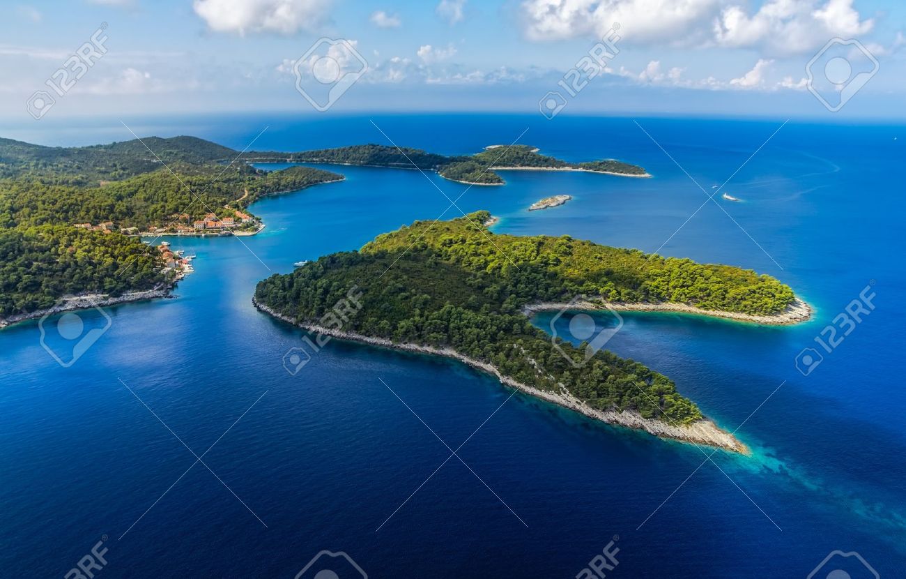 Aerial helicopter shoot of National park on island Mljet, village Pomena, Dubrovnik archipelago, Croatia. The oldest pine forest in Europe preserved. - 18808398 Aerial helicopter shoot of National park on island Mljet, village Pomena, Dubrovnik archipelago, Croatia. The oldest pine forest in Europe preserved. - 18808398