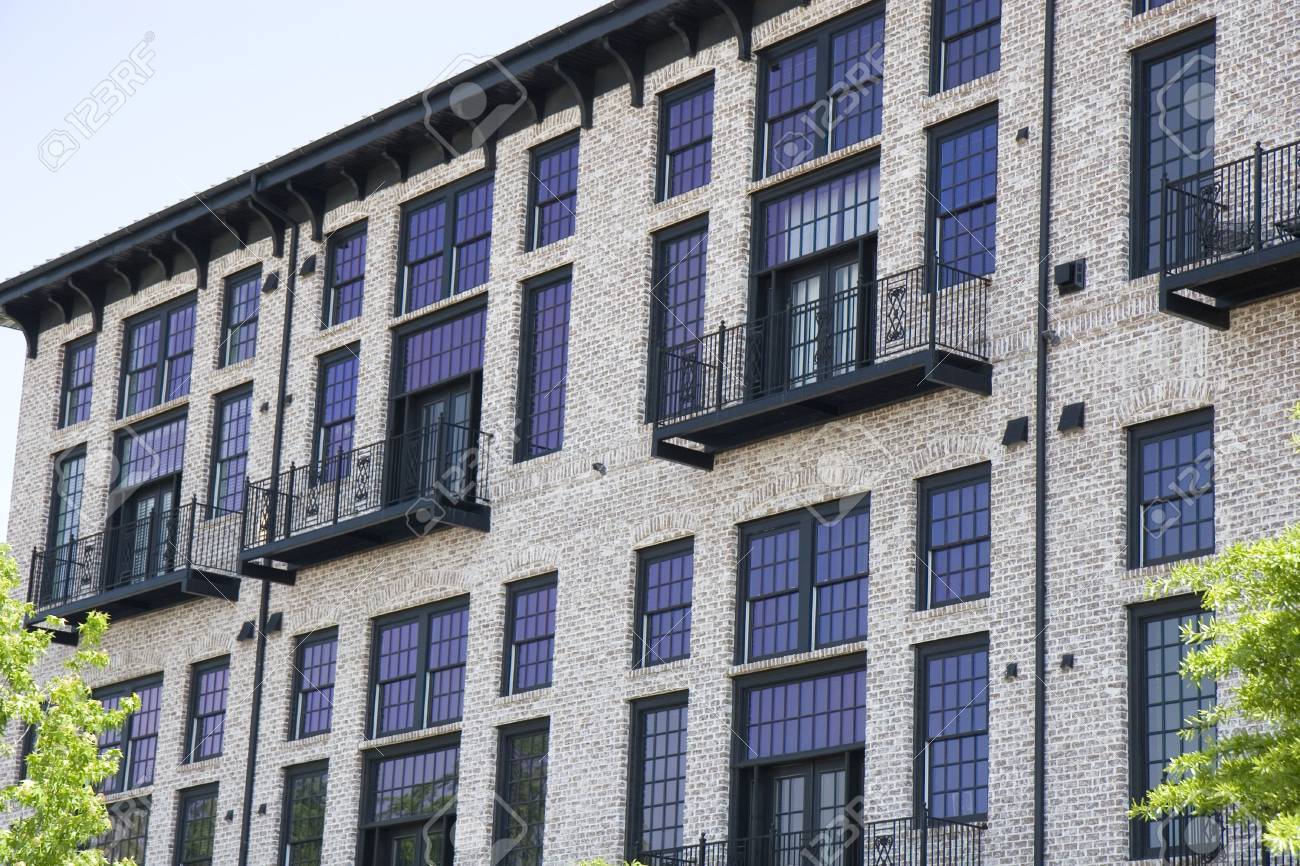 Brick Loft Apartment a brick loft apartment building with colorful purple windows stock Brick Loft Apartment a brick loft apartment building with colorful purple windows stock