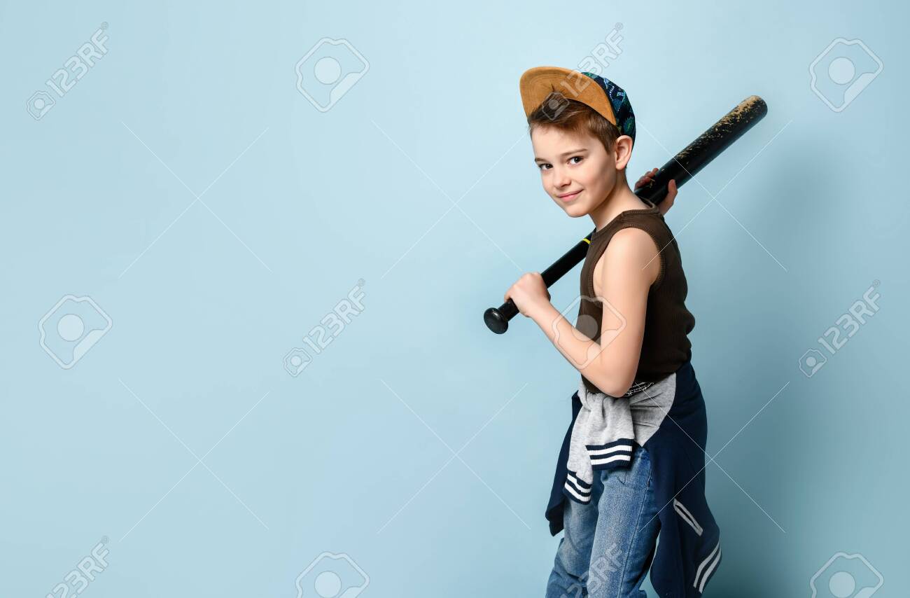 Sportlicher kleiner junge in ärmellosem hemd, jeans und mütze, der sich darauf vorbereitet, mit einem baseballschläger von seiner schulter zu schlagen. kindheit, frech, unruhestifter. seitenansicht erschossen isoliert auf blauem hintergrund. platz kopieren - 148299255 Sportlicher kleiner junge in ärmellosem hemd, jeans und mütze, der sich darauf vorbereitet, mit einem baseballschläger von seiner schulter zu schlagen. kindheit, frech, unruhestifter. seitenansicht erschossen isoliert auf blauem hintergrund. platz kopieren - 148299255