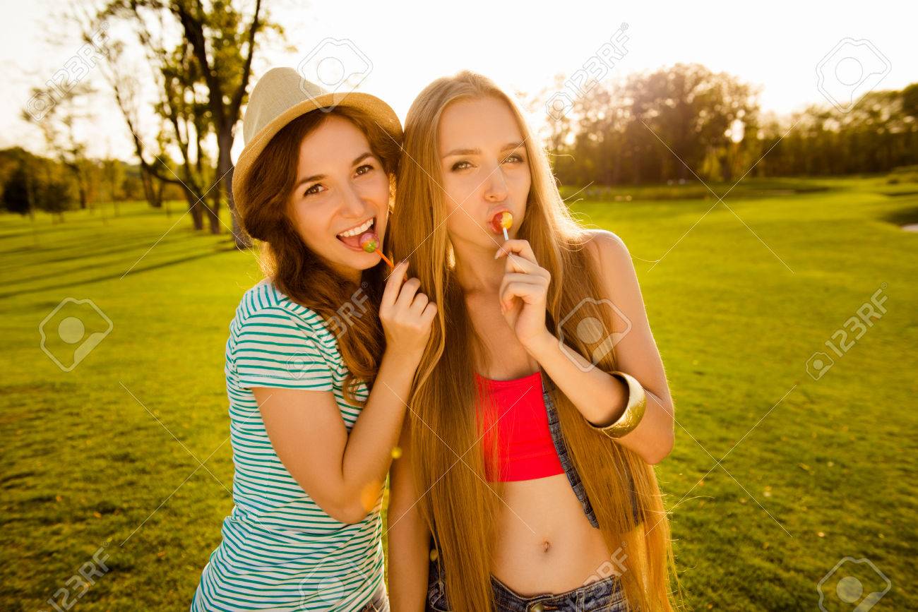Stock Photo - Two playful sexy girls licking lollipops Two Playful Sexy Girls Licking Lollipops Stock Photo, Picture And ...