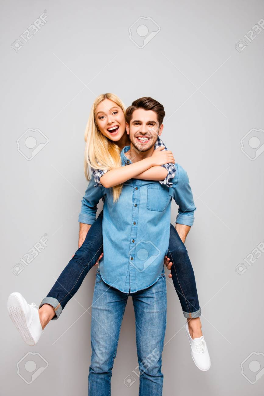 Cute couple in love traveling. Happy man carrying his joyful girlfriend on the back - 59056619 Cute couple in love traveling. Happy man carrying his joyful girlfriend on the back - 59056619