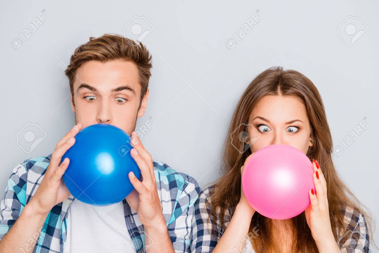 面白い幸せな若い男と風船を膨らませる女性の肖像画 の写真素材 画像素材 Image 面白い幸せな若い男と風船を膨らませる女性の肖像画 の写真素材 画像素材 Image