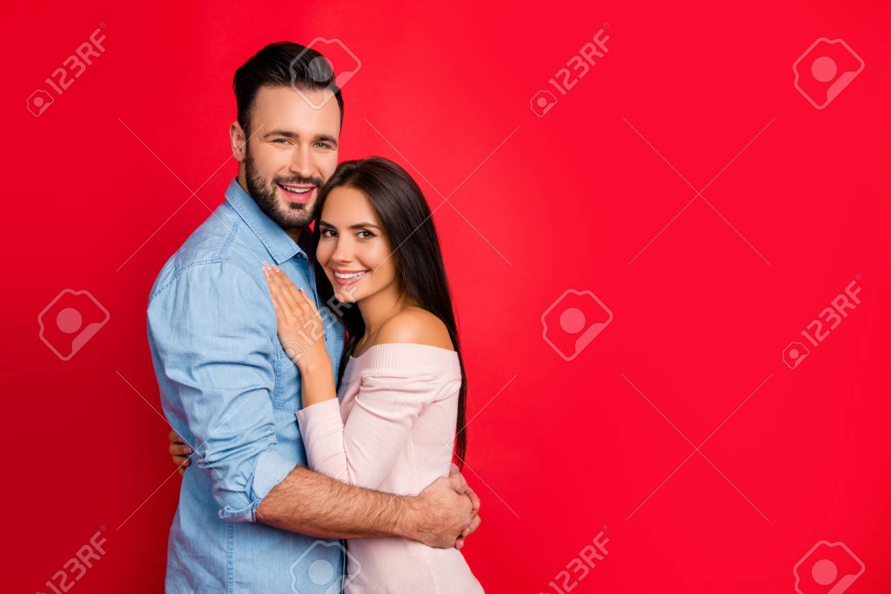 Portrait Of Beautiful, Cheerful, Positive, Cute, Sexy Couple Enjoying Hug  And Bonding With Each Other, Looking At Camera Over Red Background On 14  February, Perfect Relations Between Wife And Husband Stock Photo,, image size:1300x867