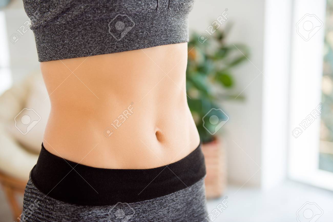Body part wellness wellbeing eating nutrition lifestyle concept. Close up cropped photo of fit slim slender sportive skinny with pecs and ideal flawless perfect skin woman's belly - 105972845 Body part wellness wellbeing eating nutrition lifestyle concept. Close up cropped photo of fit slim slender sportive skinny with pecs and ideal flawless perfect skin woman's belly - 105972845