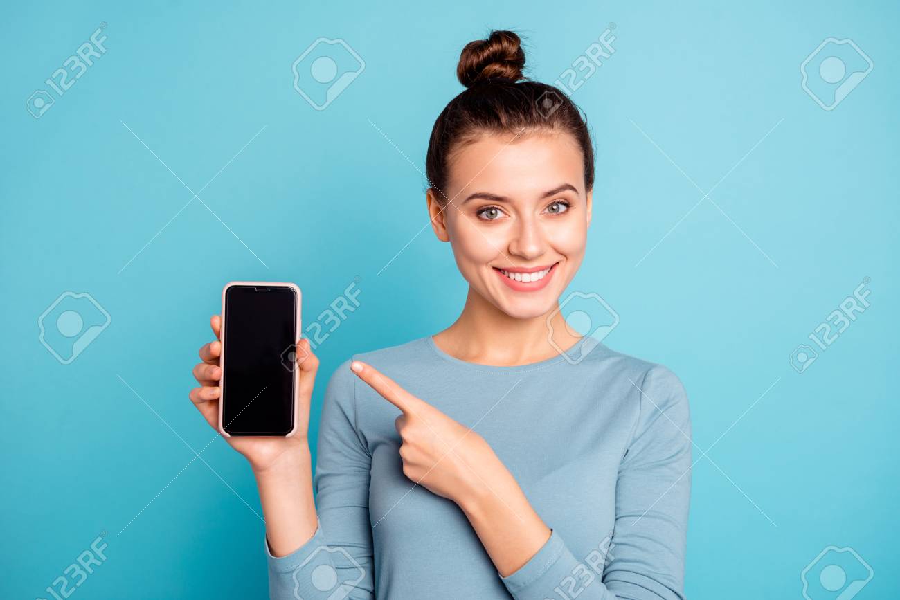 Close-up portrait of her she nice-looking attractive sweet lovely cheerful teenage girl holding in hand new cool buying purchase ad advert isolated over bright vivid shine turquoise background - 121967016 Close-up portrait of her she nice-looking attractive sweet lovely cheerful teenage girl holding in hand new cool buying purchase ad advert isolated over bright vivid shine turquoise background - 121967016