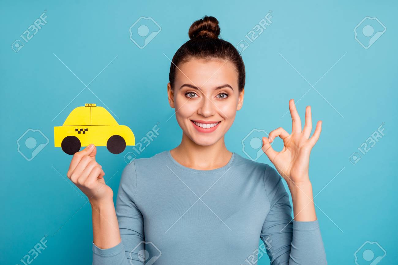 Close up photo top-knot positive satisfied cheerful hipster advertise choose advert feedback hold hand paper card yellow taxi car cab route trendy stylish beautiful shirt isolated blue background - 121968408 Close up photo top-knot positive satisfied cheerful hipster advertise choose advert feedback hold hand paper card yellow taxi car cab route trendy stylish beautiful shirt isolated blue background - 121968408