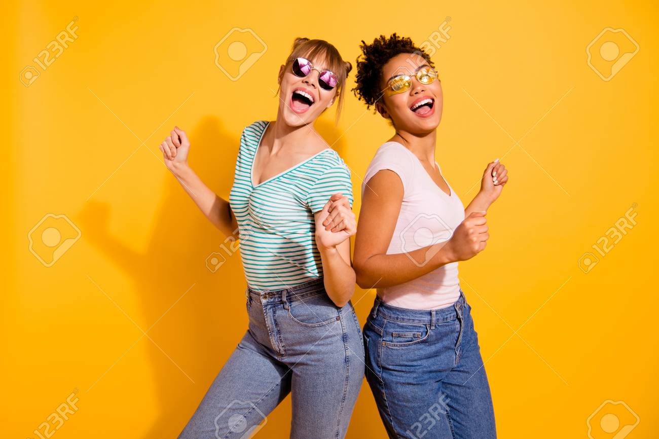 Close up photo beautiful funny she her lady party guys hands arms raised up modern motion different nationalities wear sun specs casual white striped t-shirt clothes isolated yellow bright background - 123700815 Close up photo beautiful funny she her lady party guys hands arms raised up modern motion different nationalities wear sun specs casual white striped t-shirt clothes isolated yellow bright background - 123700815