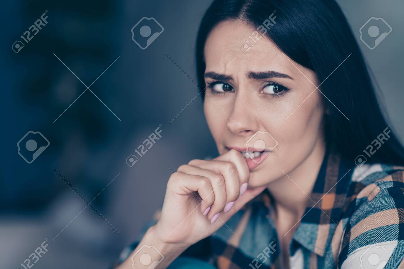 Close up side profile photo she her lady displeased hopeless arm hand bite fingers nerves made mistake have doubts tell or no wear checkered plaid shirt sit lean divan flat house living room indoors - 127523884 Close up side profile photo she her lady displeased hopeless arm hand bite fingers nerves made mistake have doubts tell or no wear checkered plaid shirt sit lean divan flat house living room indoors - 127523884
