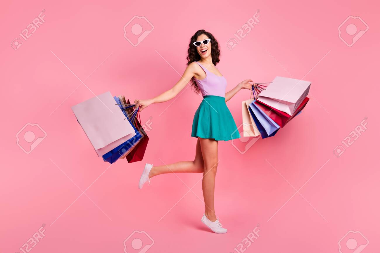 Full length body size photo of cheerful trendy stylish carefree cute attractive gorgeous woman rejoicing with sales wearing teal skirt while isolated with pastel background - 129733567 Full length body size photo of cheerful trendy stylish carefree cute attractive gorgeous woman rejoicing with sales wearing teal skirt while isolated with pastel background - 129733567