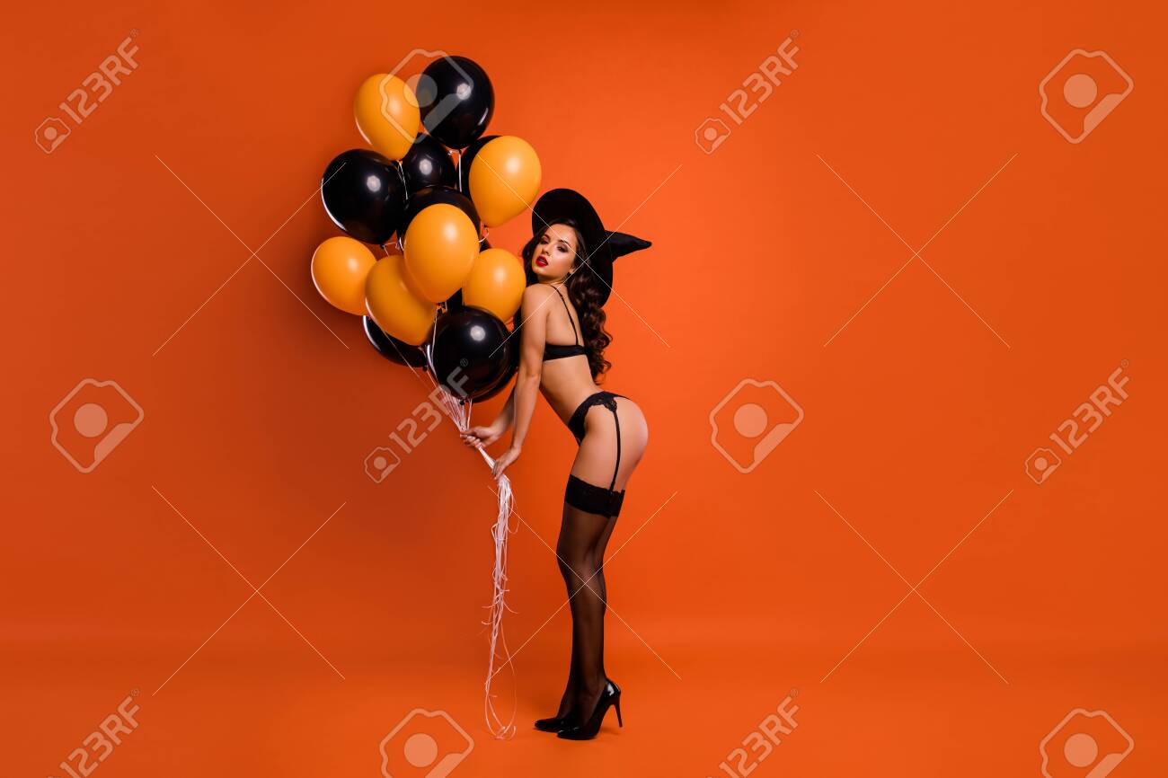 Full size photo of beautiful lady hold air balloons make private party showing husband ideal figure wear black bikini tights witch cap isolated orange background - 130571933 Full size photo of beautiful lady hold air balloons make private party showing husband ideal figure wear black bikini tights witch cap isolated orange background - 130571933