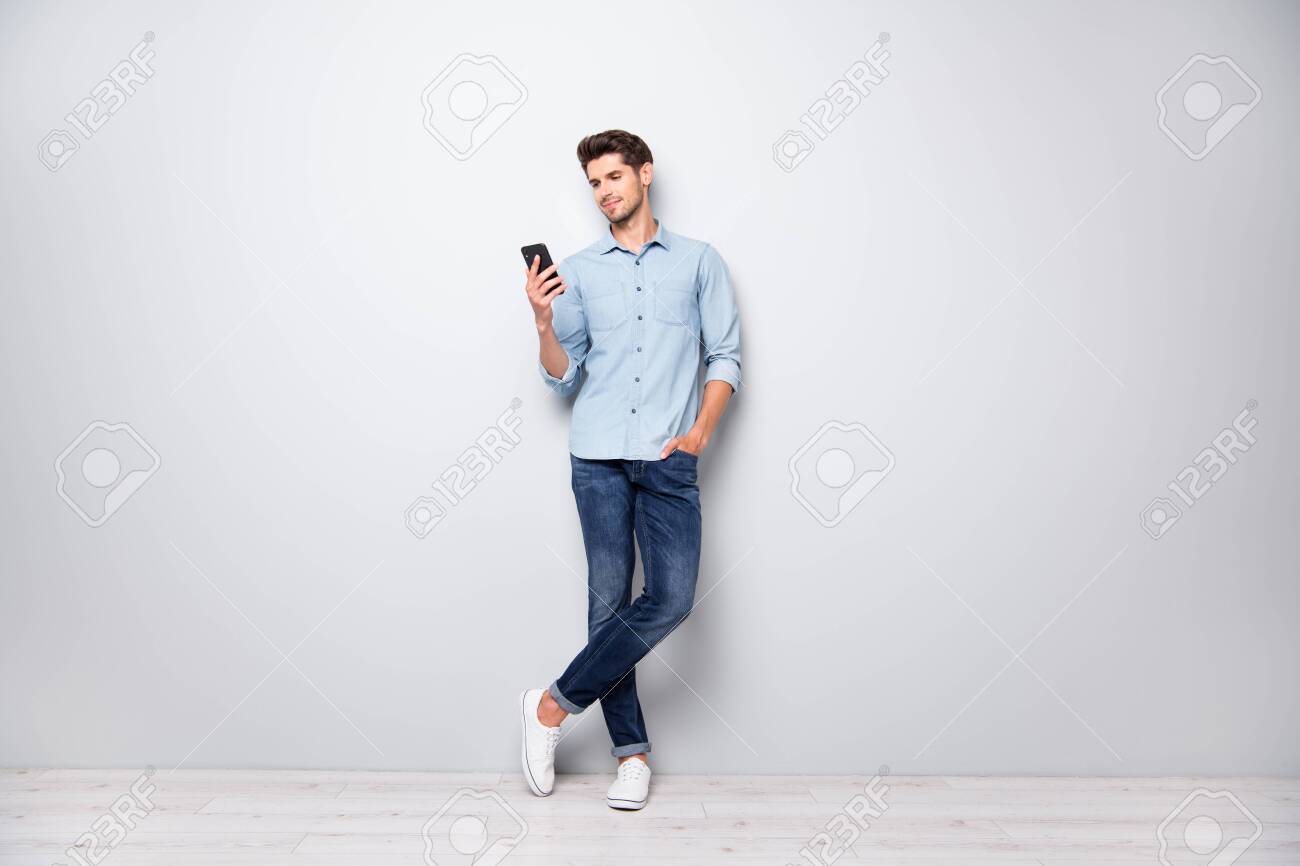 Full size photo of concentrated smm worker man use cellphone answer sms messages have online conversation with friends type comments posts wear stylish outfit sneakers isolated grey color background - 132532197 Full size photo of concentrated smm worker man use cellphone answer sms messages have online conversation with friends type comments posts wear stylish outfit sneakers isolated grey color background - 132532197