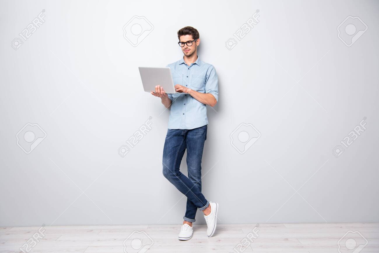 Full length body size photo of focused serious intelligent coworking manager standing confidently with legs crossed searching for news via internet connection isolated grey color background - 132532443 Full length body size photo of focused serious intelligent coworking manager standing confidently with legs crossed searching for news via internet connection isolated grey color background - 132532443