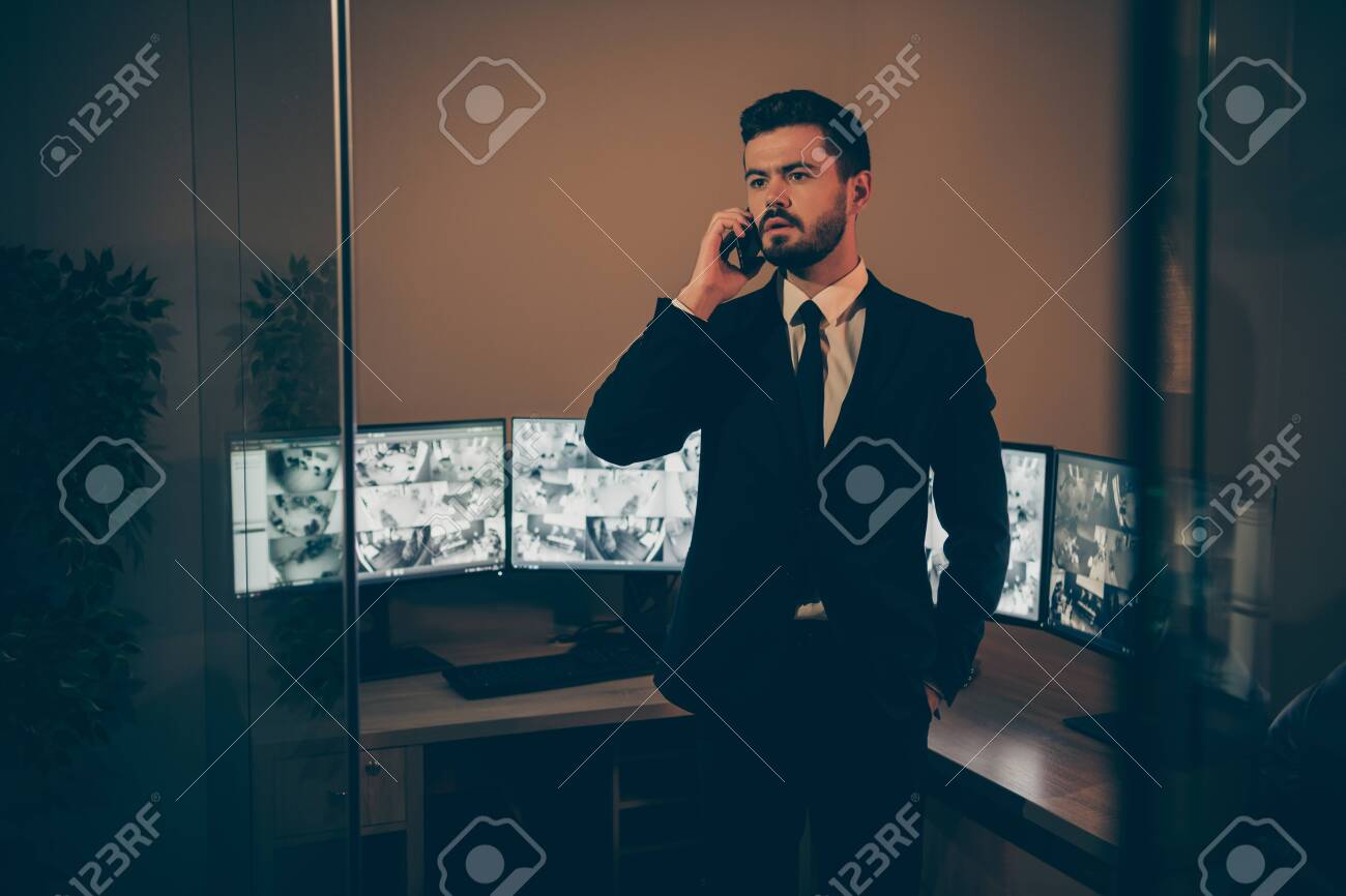 Portrait of his he nice attractive serious professional experienced stylish imposing man supervising online remote panel night shift talking to partner at work place station - 135269215 Portrait of his he nice attractive serious professional experienced stylish imposing man supervising online remote panel night shift talking to partner at work place station - 135269215