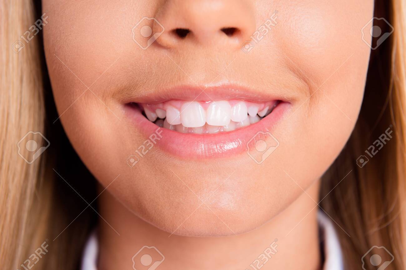 Close up cropped photo of charming lovely schoolgirl little lady mouth pink balm shiny toothy white smile teeth hygiene dentist clinic promo healthy oral care disease prevention concept - 155796453 Close up cropped photo of charming lovely schoolgirl little lady mouth pink balm shiny toothy white smile teeth hygiene dentist clinic promo healthy oral care disease prevention concept - 155796453