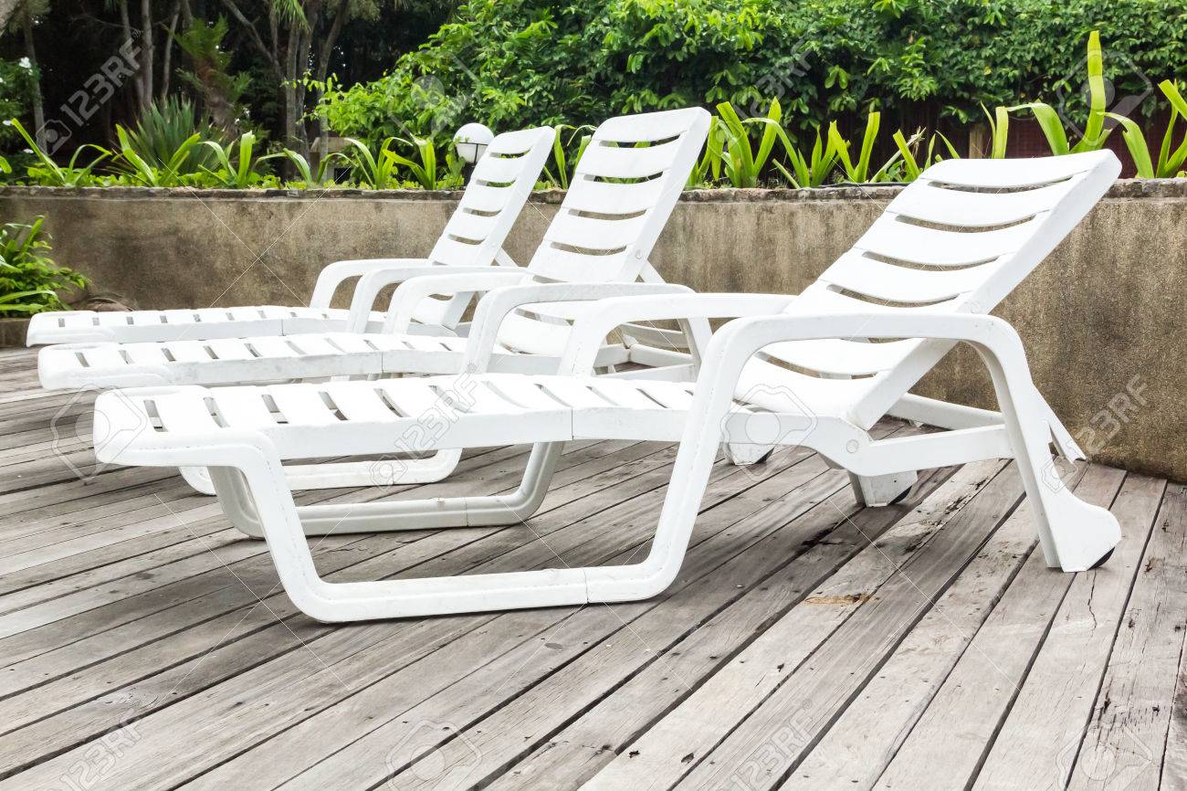 white sunloungers on wood