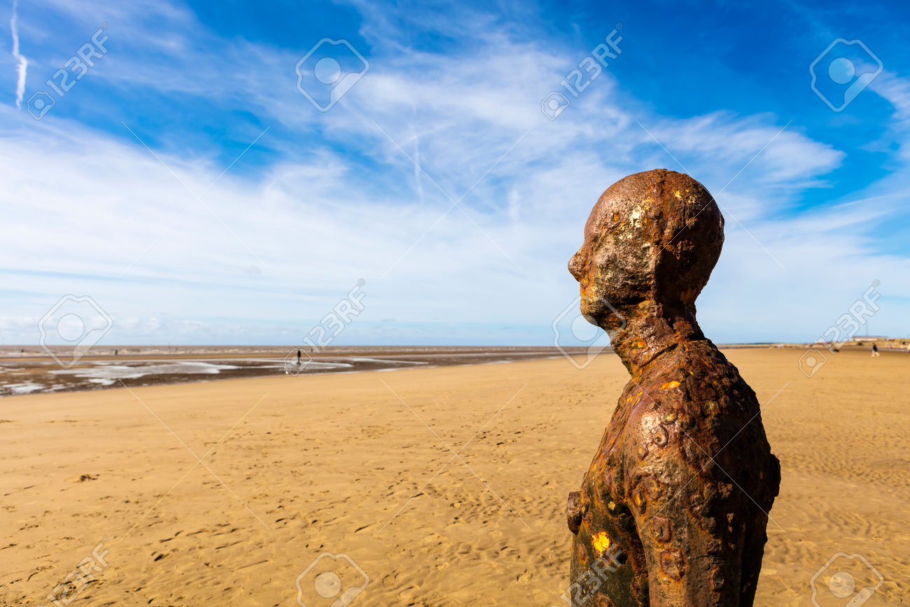 CROSBY BEACH, ENGLAND - SEPTEMBER 13, 2016: Detail of Another Place by Antony Gormley consists of 100 cast-iron, life-size figures spread out along three kilometres of the foreshore near Liverpool. - 63347190 CROSBY BEACH, ENGLAND - SEPTEMBER 13, 2016: Detail of Another Place by Antony Gormley consists of 100 cast-iron, life-size figures spread out along three kilometres of the foreshore near Liverpool. - 63347190