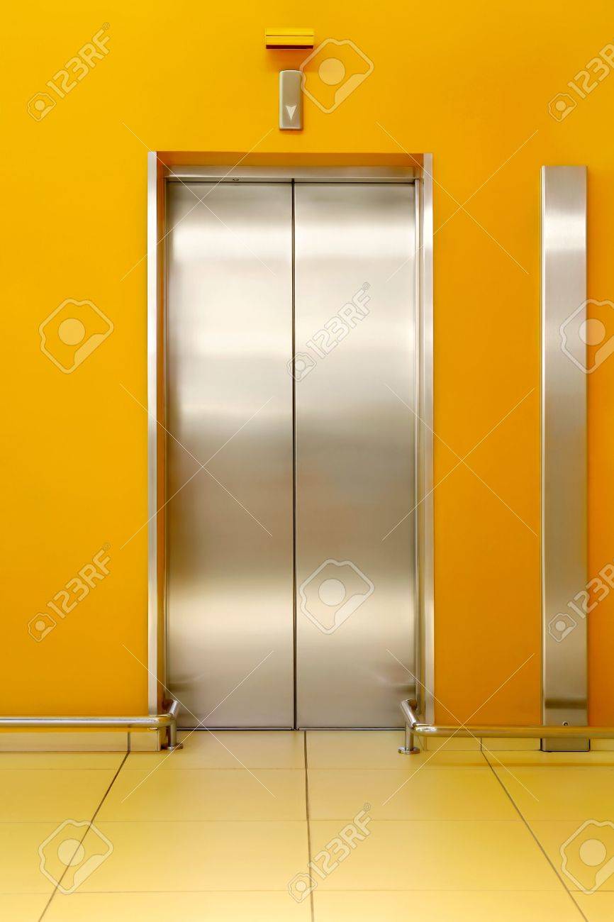 Photo Of Shining Doors Of The Lift And Orange Walls Around