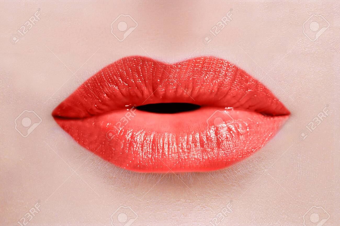 Close up of caucasian woman lips with red lipstick sending a kiss or whispering - 140552527 Close up of caucasian woman lips with red lipstick sending a kiss or whispering - 140552527