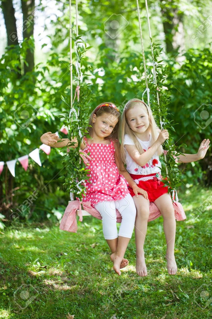 Bright Summer Berry Party In Park Two Girls On The Swing Stock Photo Picture And Royalty Free Image Image