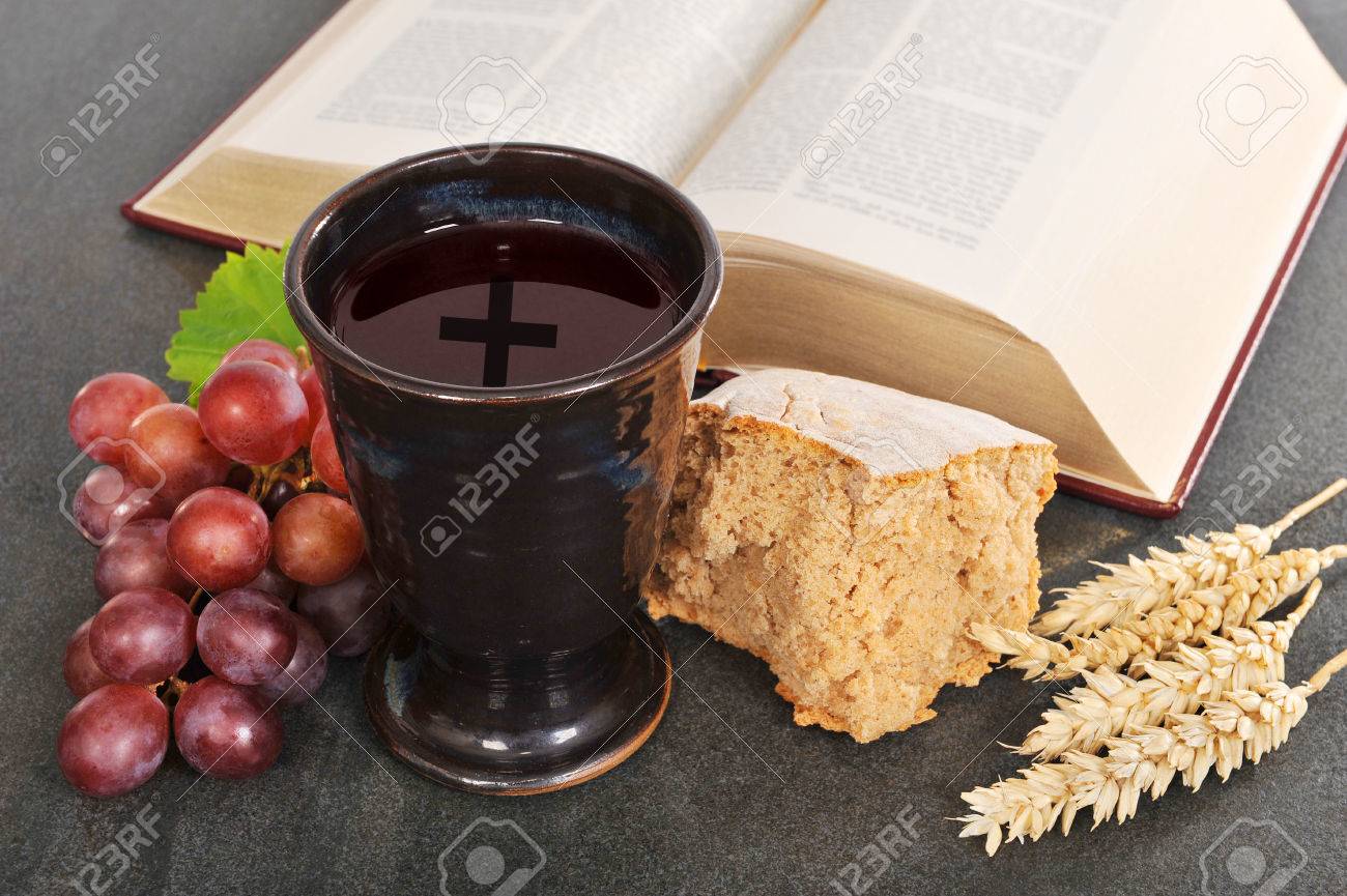 bread wine and bible for sacrament or communion stock photo