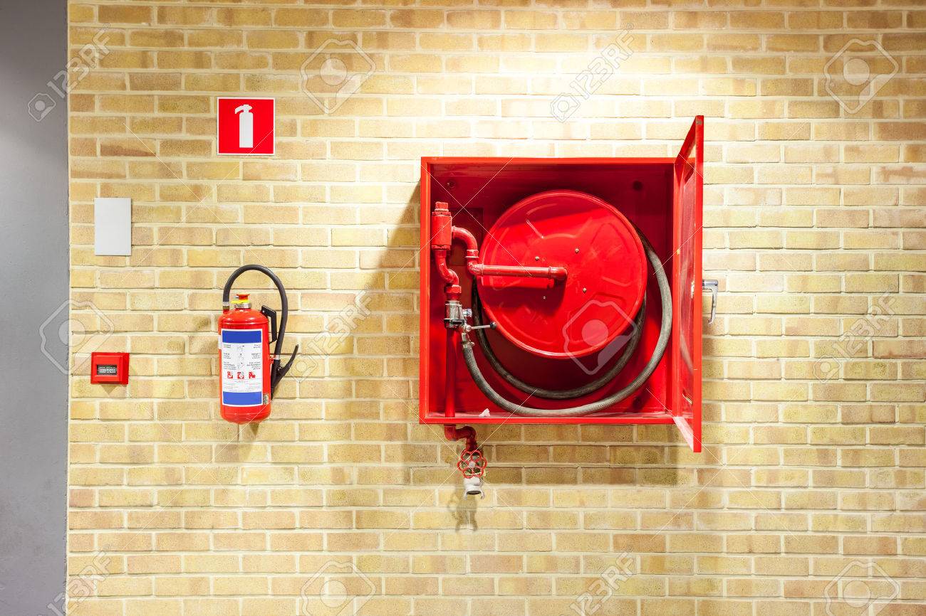 an fire hose hanging on the wall in an staircase - 64874549 an fire hose hanging on the wall in an staircase - 64874549