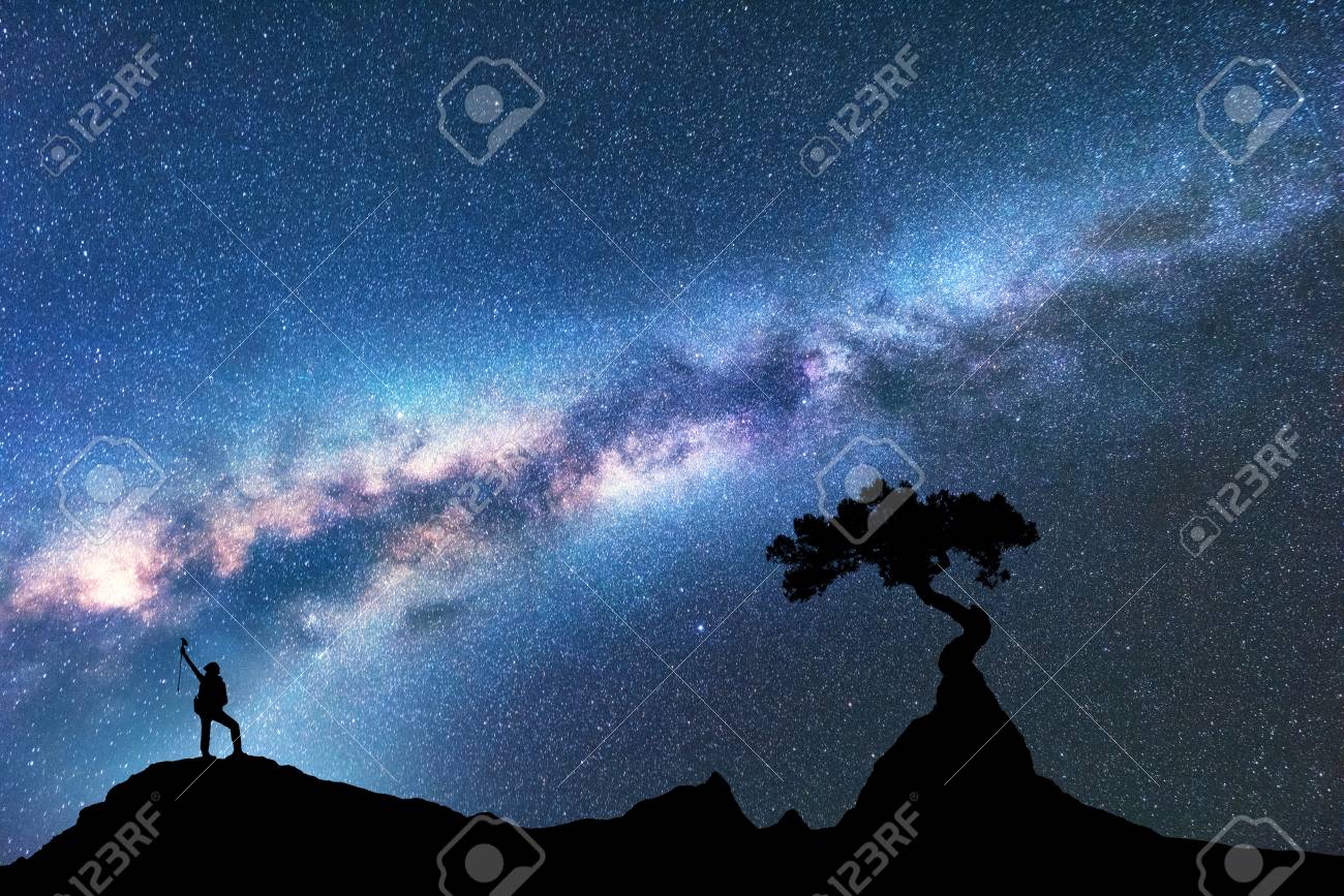 天の川 夜の山の岩から成長する女性と木のシルエット 星空 美しい銀河と女の子と宇宙の背景 青い天の川 木と女性 宇宙 冒険 の写真素材 画像素材 Image