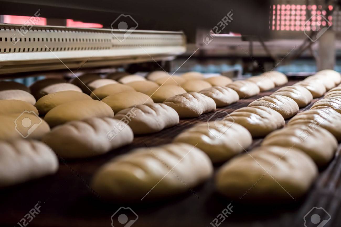 Dessert bread baking in oven. Production oven at the bakery. Baking bread. Manufacture of bread. - 55415011 Dessert bread baking in oven. Production oven at the bakery. Baking bread. Manufacture of bread. - 55415011