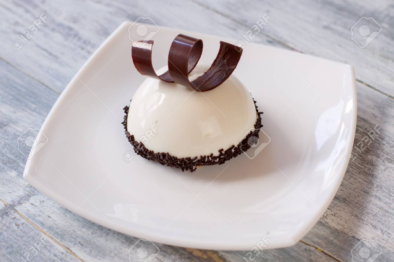 dessert with white glaze dark brown chocolate spiral moussedessert with white glaze dark brown chocolate spiral mousse cake with vanilla filling