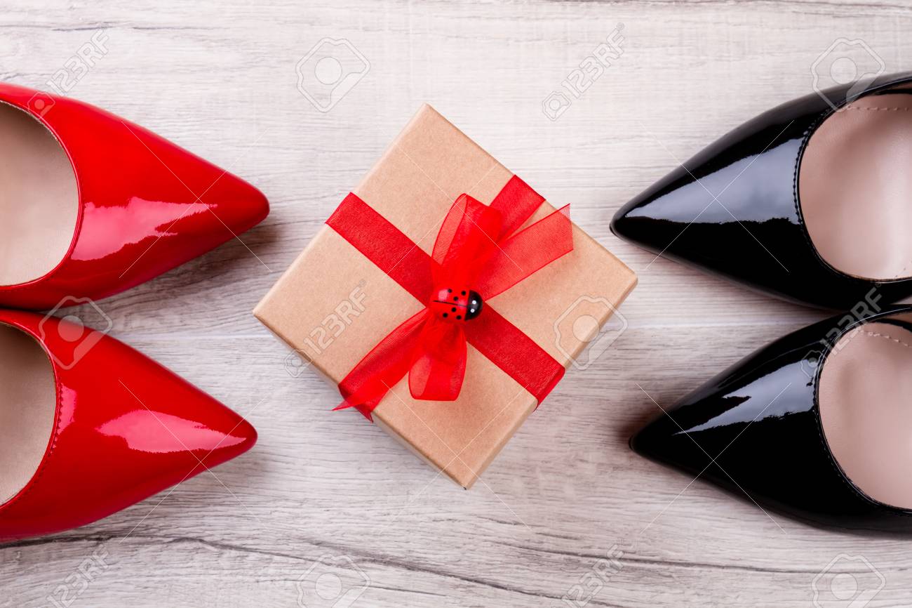 Shoes and gift box. Footwear and box with ribbon. Shoes are best..