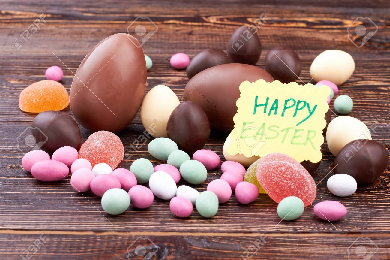 candies and happy easter card sweets on brown wood homemade