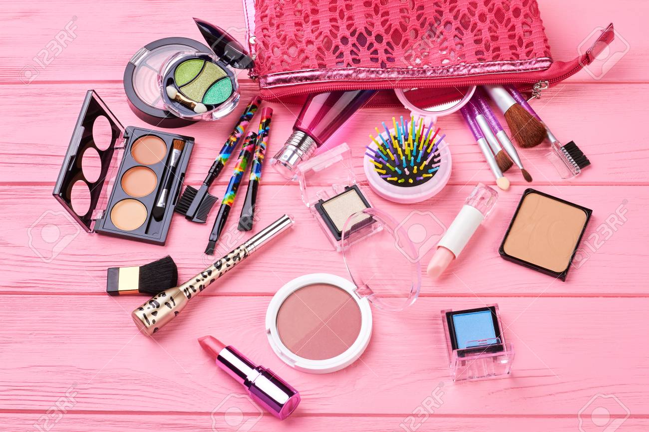 Various makeup products on wooden background. Decorative cosmetics..