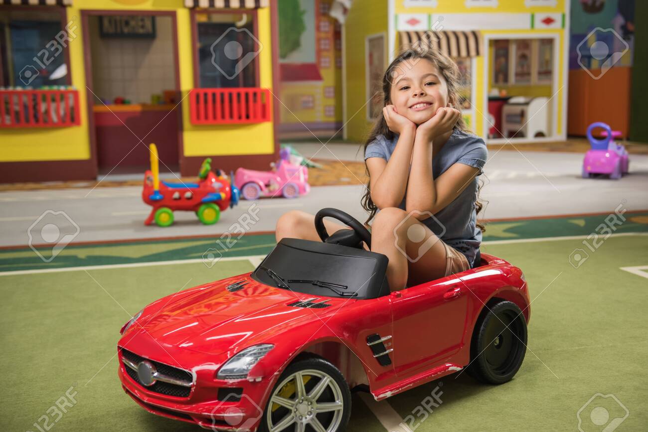 kid in toy car