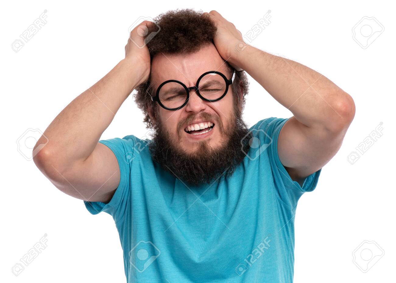 Crazy Bearded Man With Funny Curly Hair In Eye Glasses Suffering