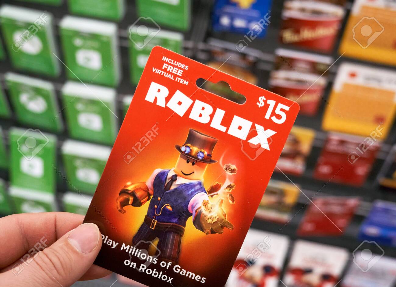 Montreal, Canada - March 22, 2020: Roblox Gift Card In A Hand Over Gift  Cards Background. Roblox Is A Multiplayer Online Video Game And Game  Creation System That Allows Users To Design