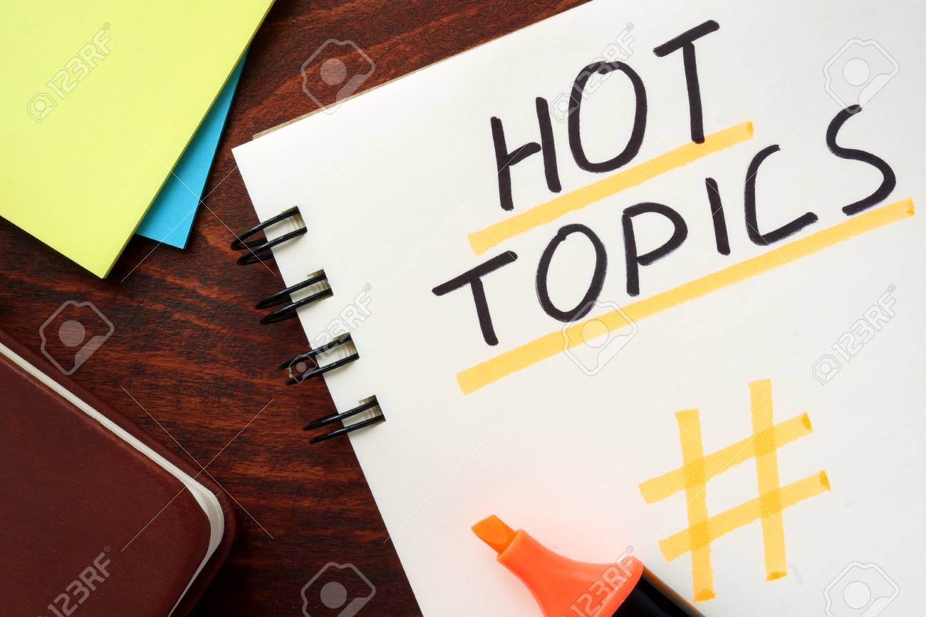 Hot Topics written in a notepad on a wooden background. - 56029651 Hot Topics written in a notepad on a wooden background. - 56029651