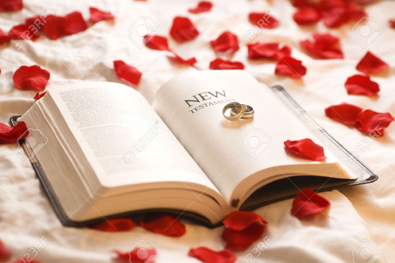 rings on the bible wedding rings on the new testament bible stock