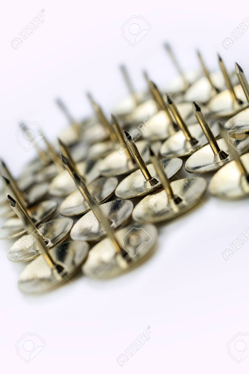 a medium collection of thumbtacks in a white box crooked angle